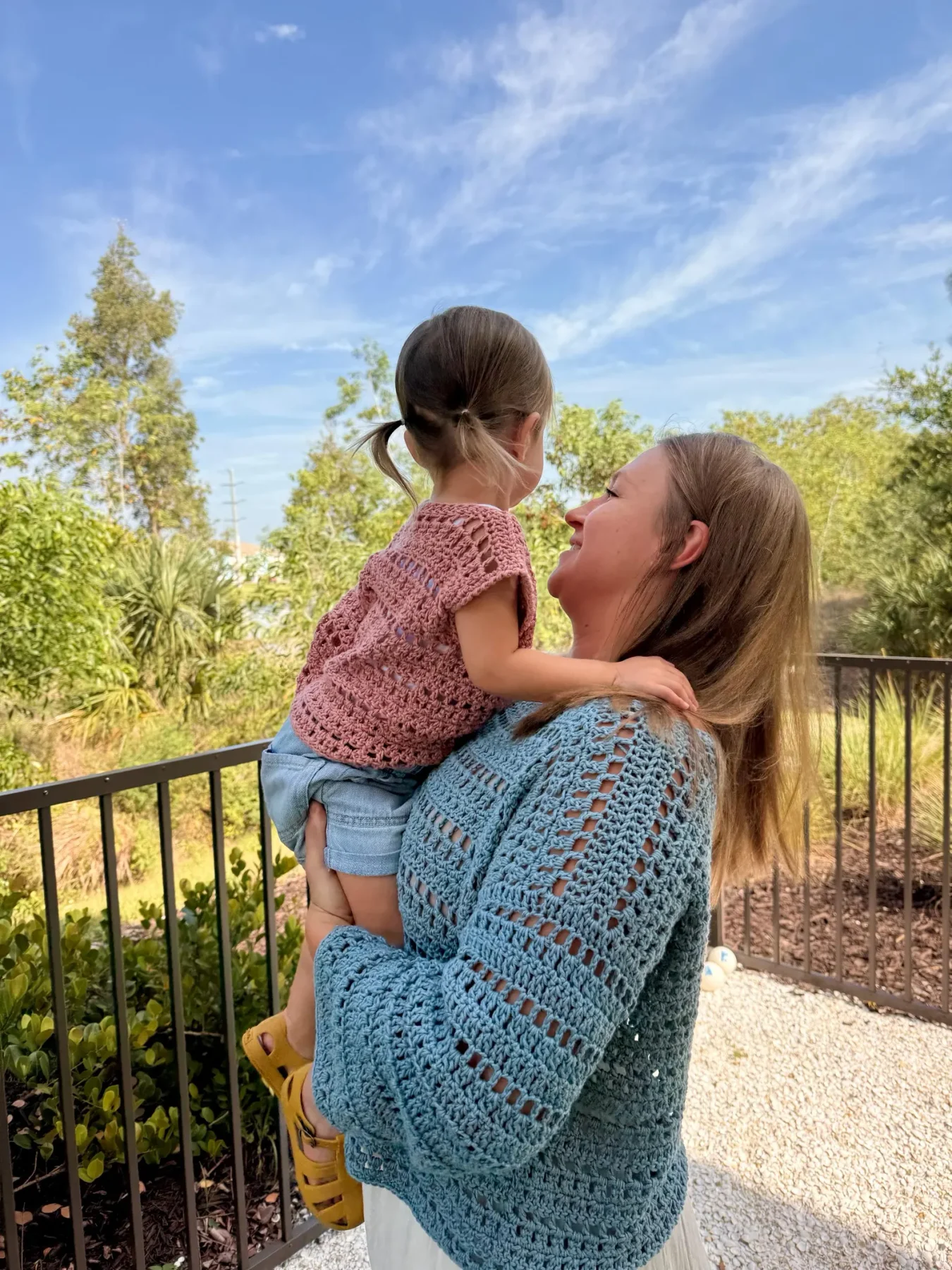 Matching blue and pink Saltwater Drift crochet tops worn on a sunny Florida day
